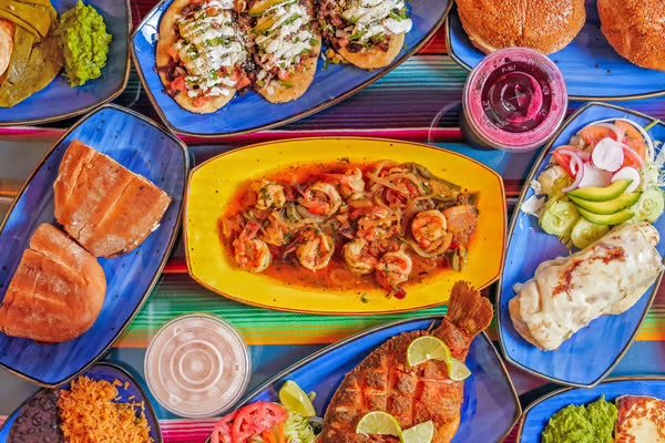 Mexican dishes arranged on white plates.